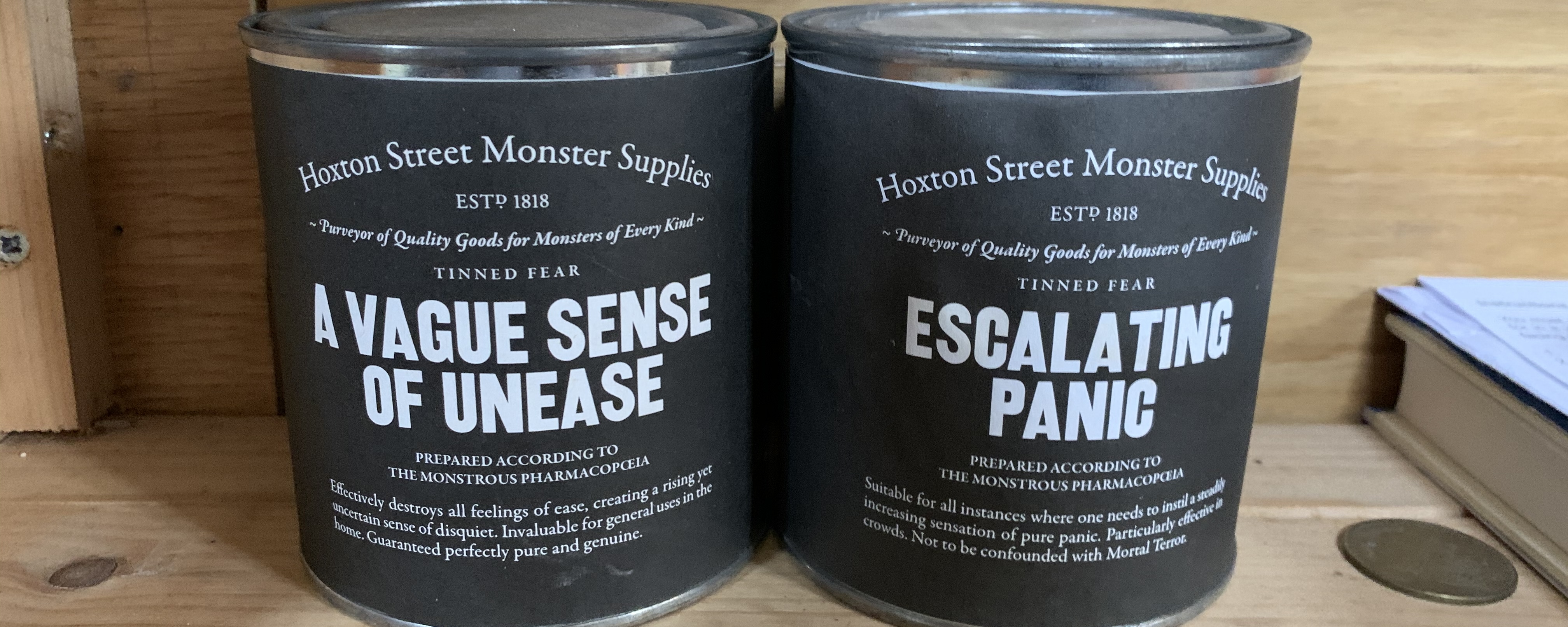 tins from Hoxton Street Monster Supplies reading "a vague sense of unease" and "escalating panic"